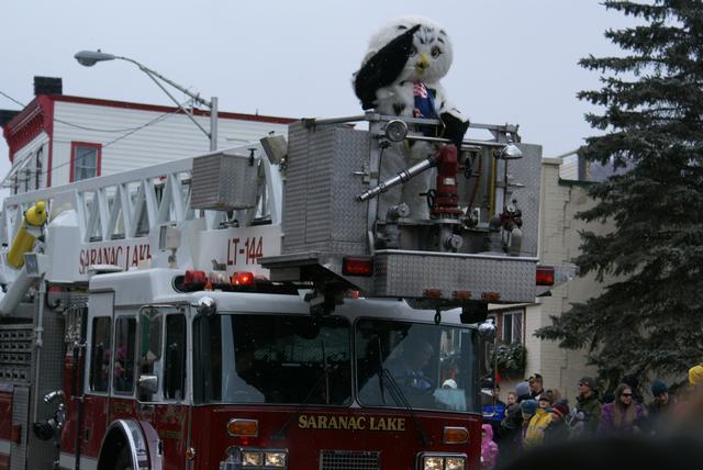 Sara the Snowy Owl waves to crowd atop of Ladder 144, Winter Carnival 2012